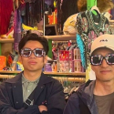International students wear wacky glasses in a fun shop in San Francisco