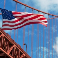 USA flag in front of the Golden Gate Bridge