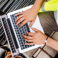 Construction worker using a laptop